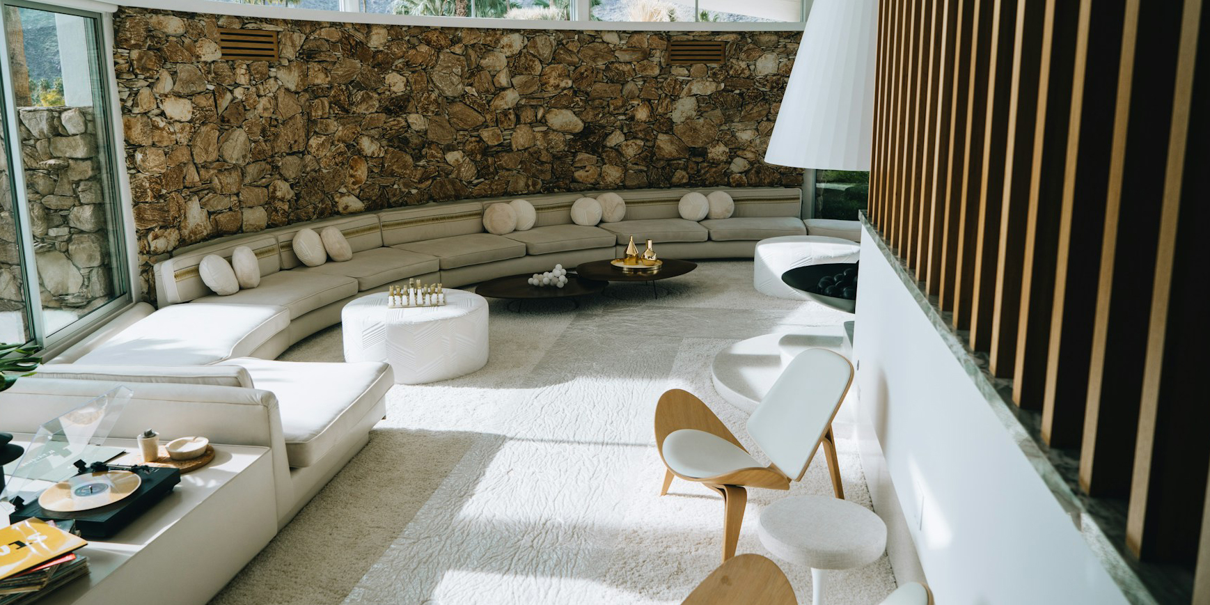 Mid Century Modern home with curved stone wall and built-in seating area