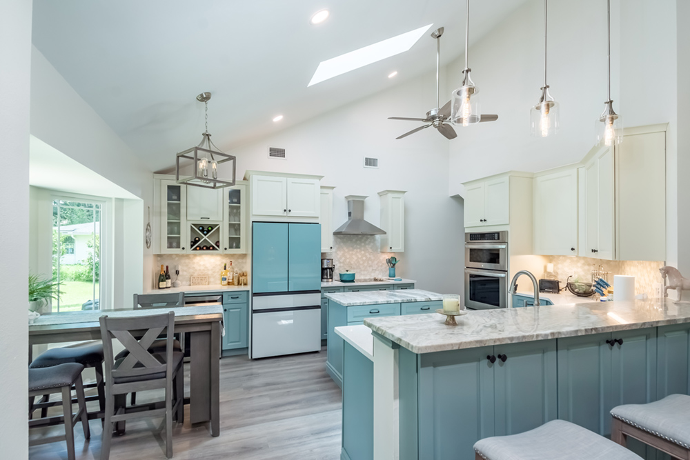 A stunning kitchen with custom blue and white cabinets.