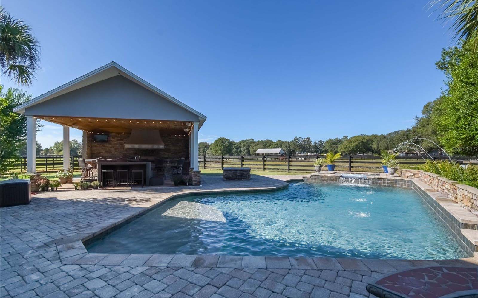 A shady lanai with ceiling fan and lots of room for seating.