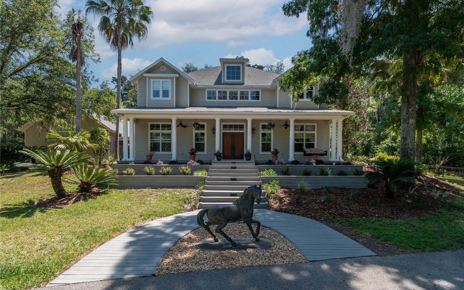 A beautiful home with mature landscaping and flowering shrubs.