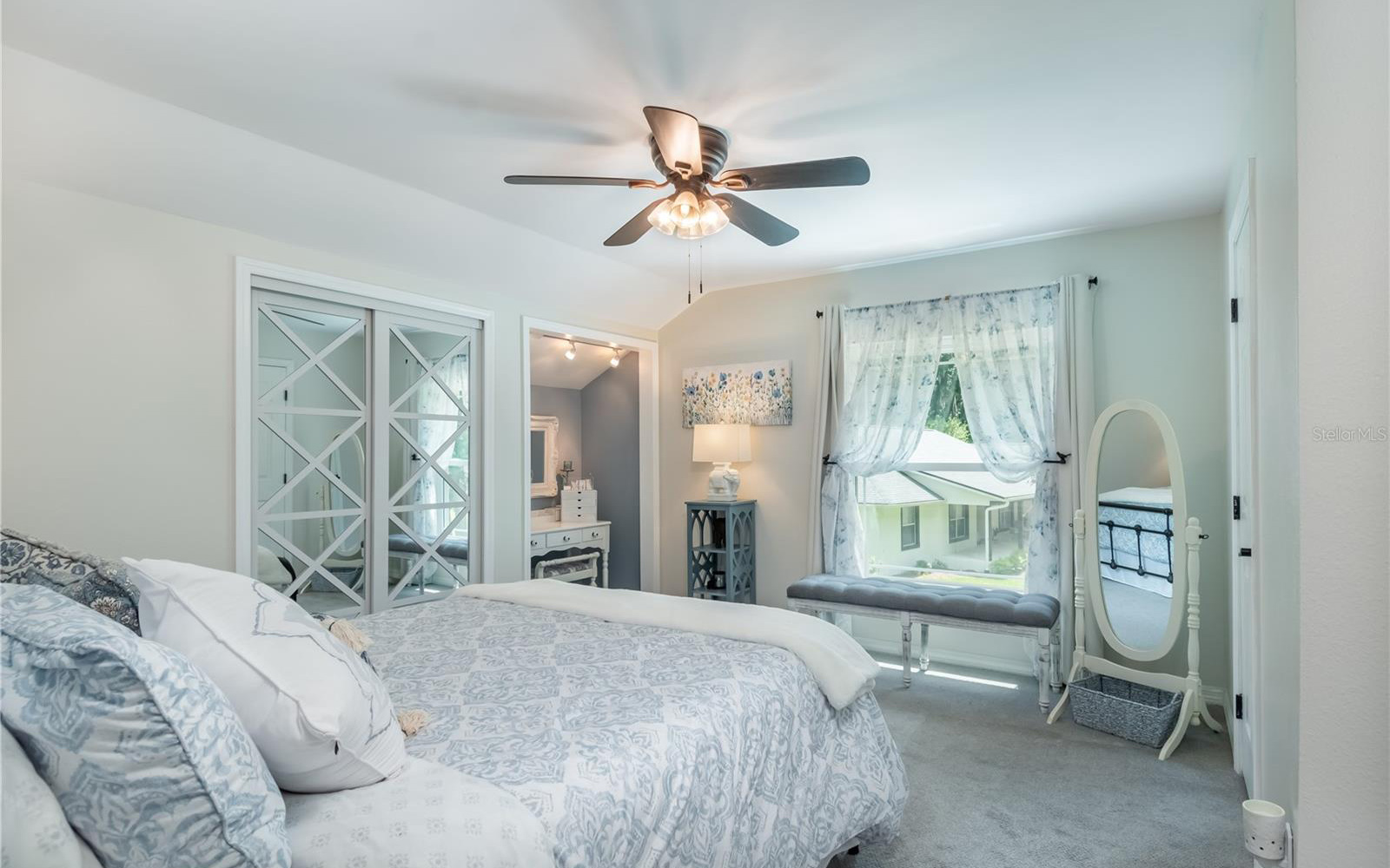 A serene blue and white bedroom.