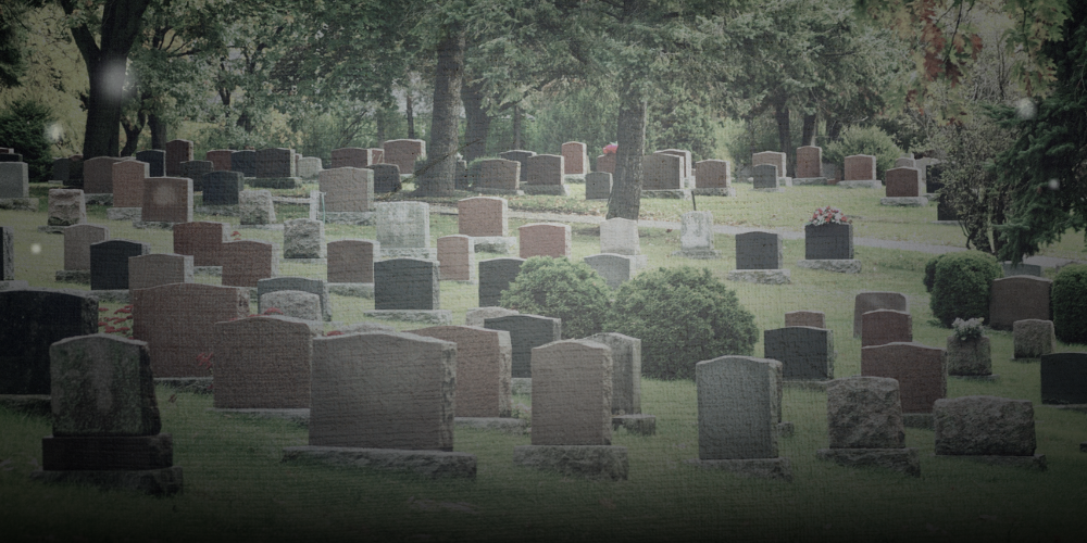 A spooky cemetery with headstones and ghostly orbs.